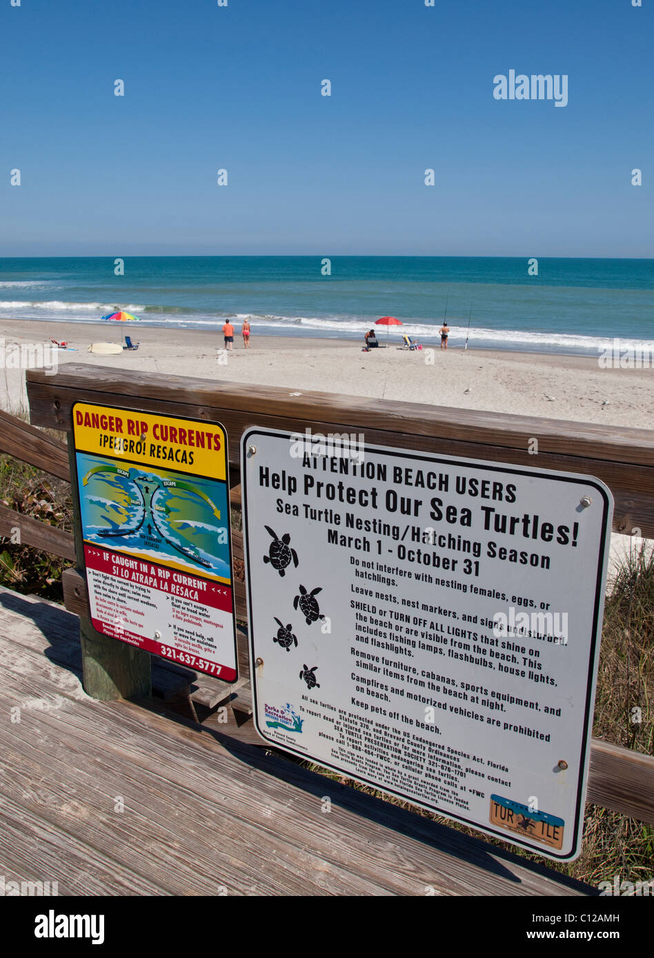 Rip current and sea turtle beach warning signs on Melbourne Beach in Florida Stock Photo