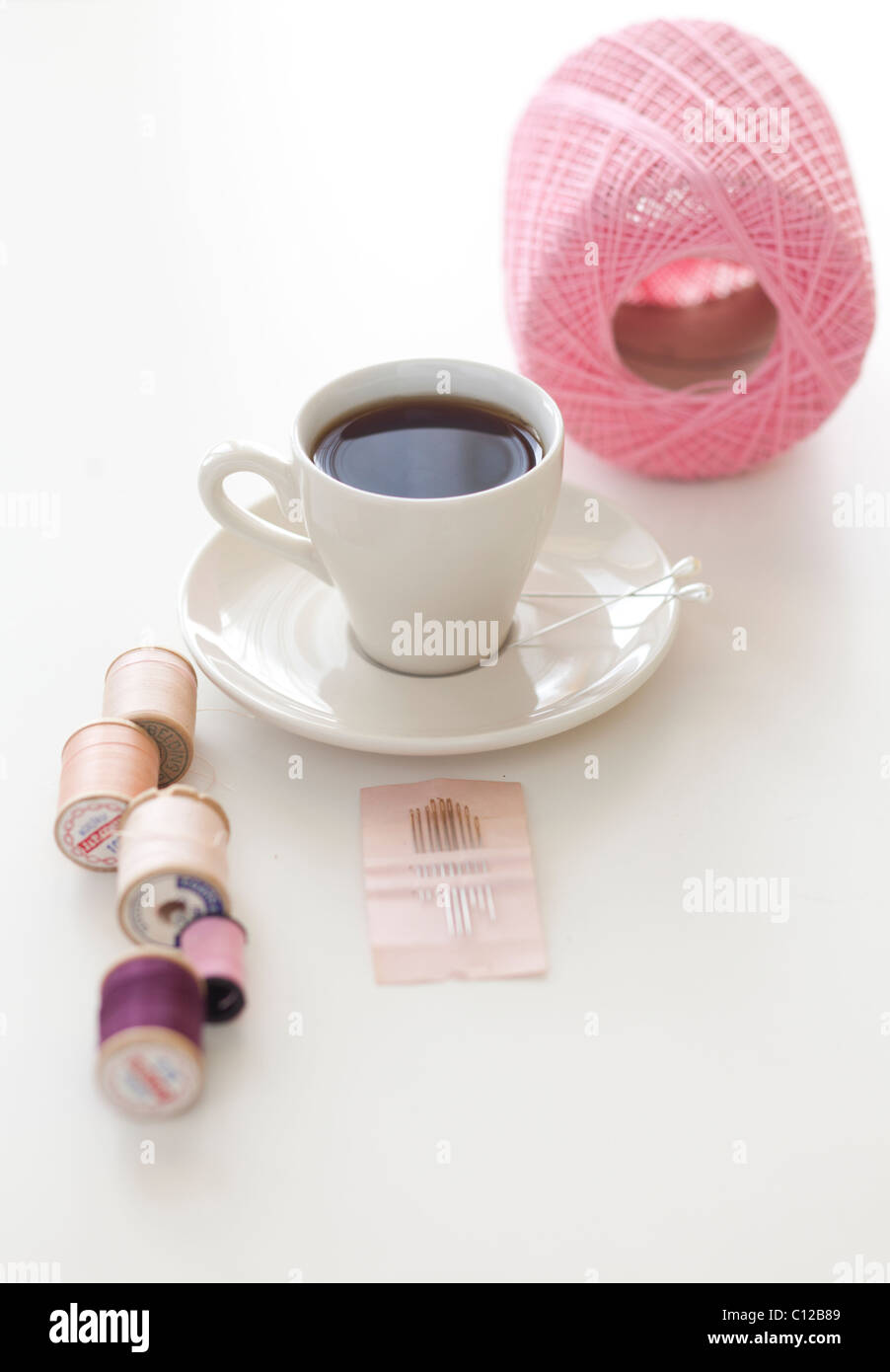 tea cup with pink sewing materials Stock Photo