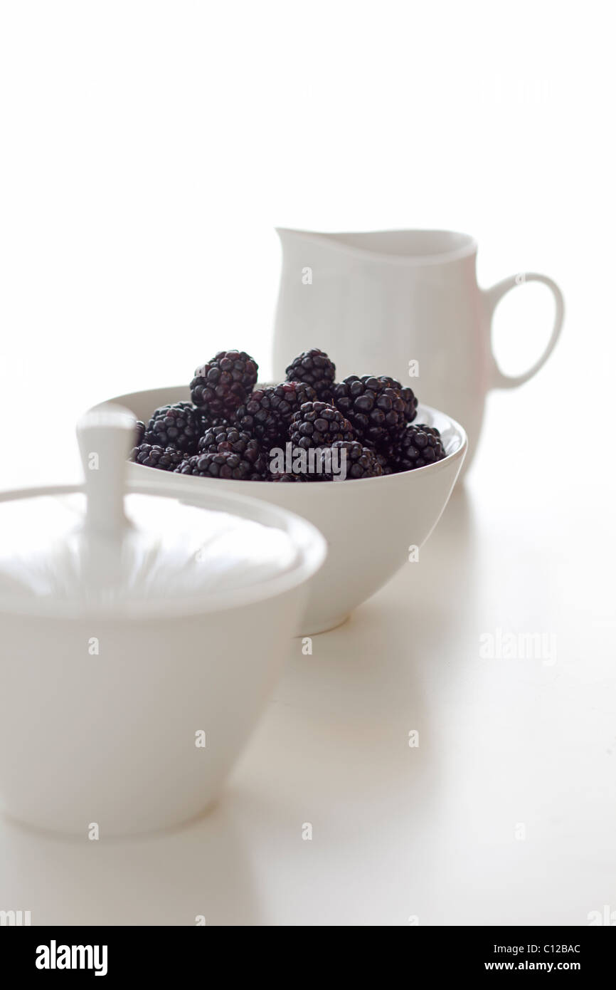 bowl of blackberries with cream and sugar Stock Photo