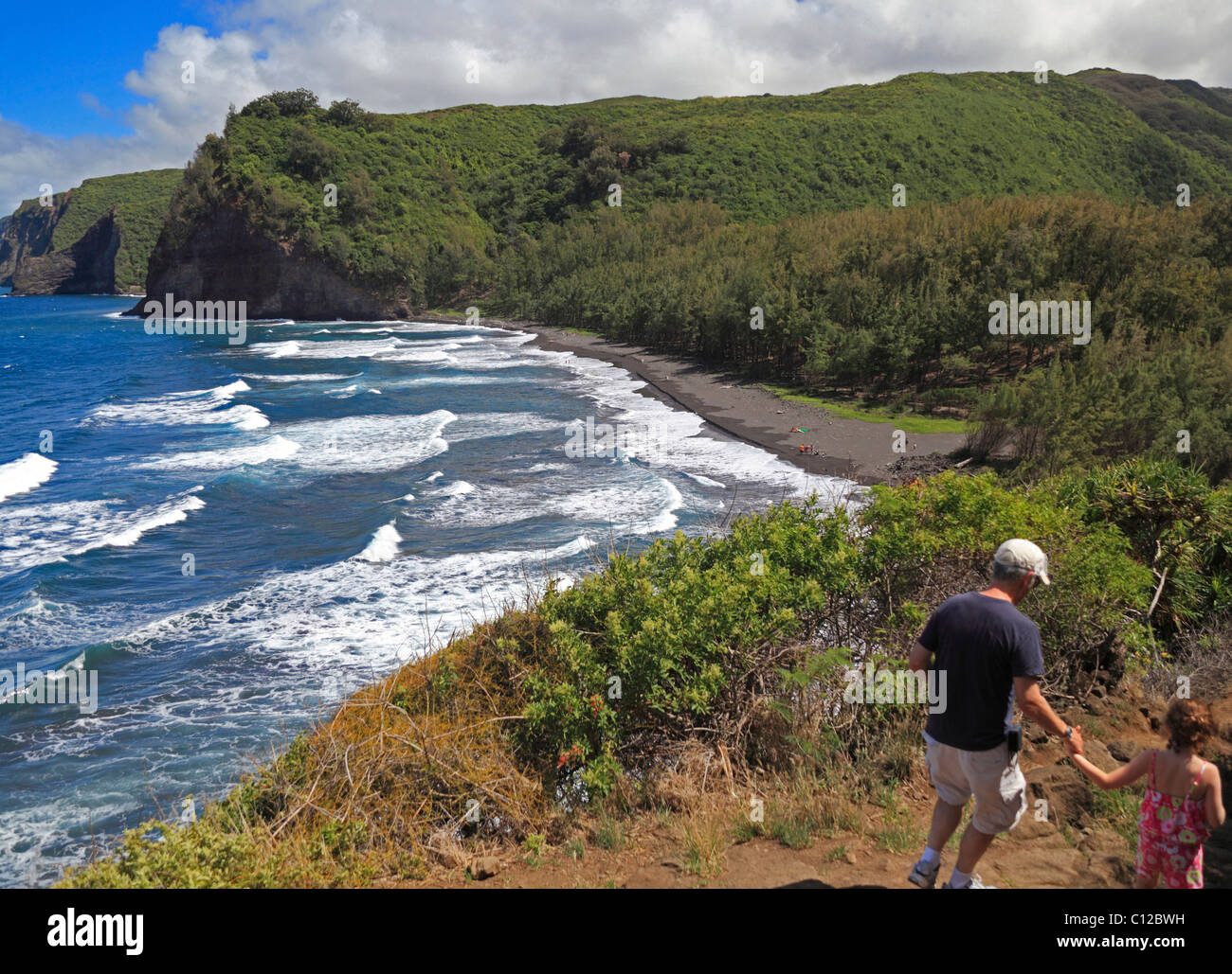 Hikers on the Pololu Valley trail on the Big Island Stock Photo