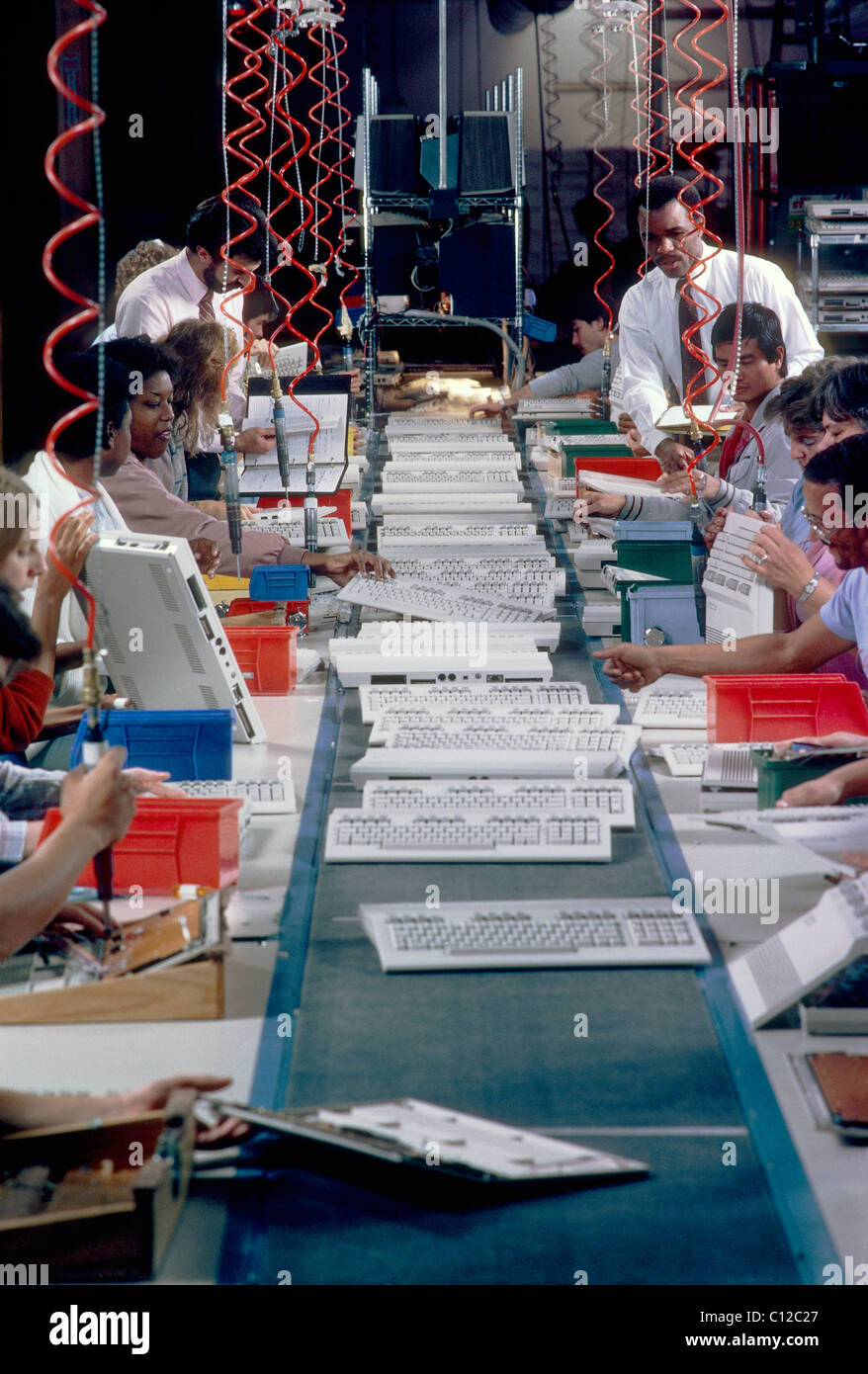 Assembly line workers building computer keyboards Stock Photo