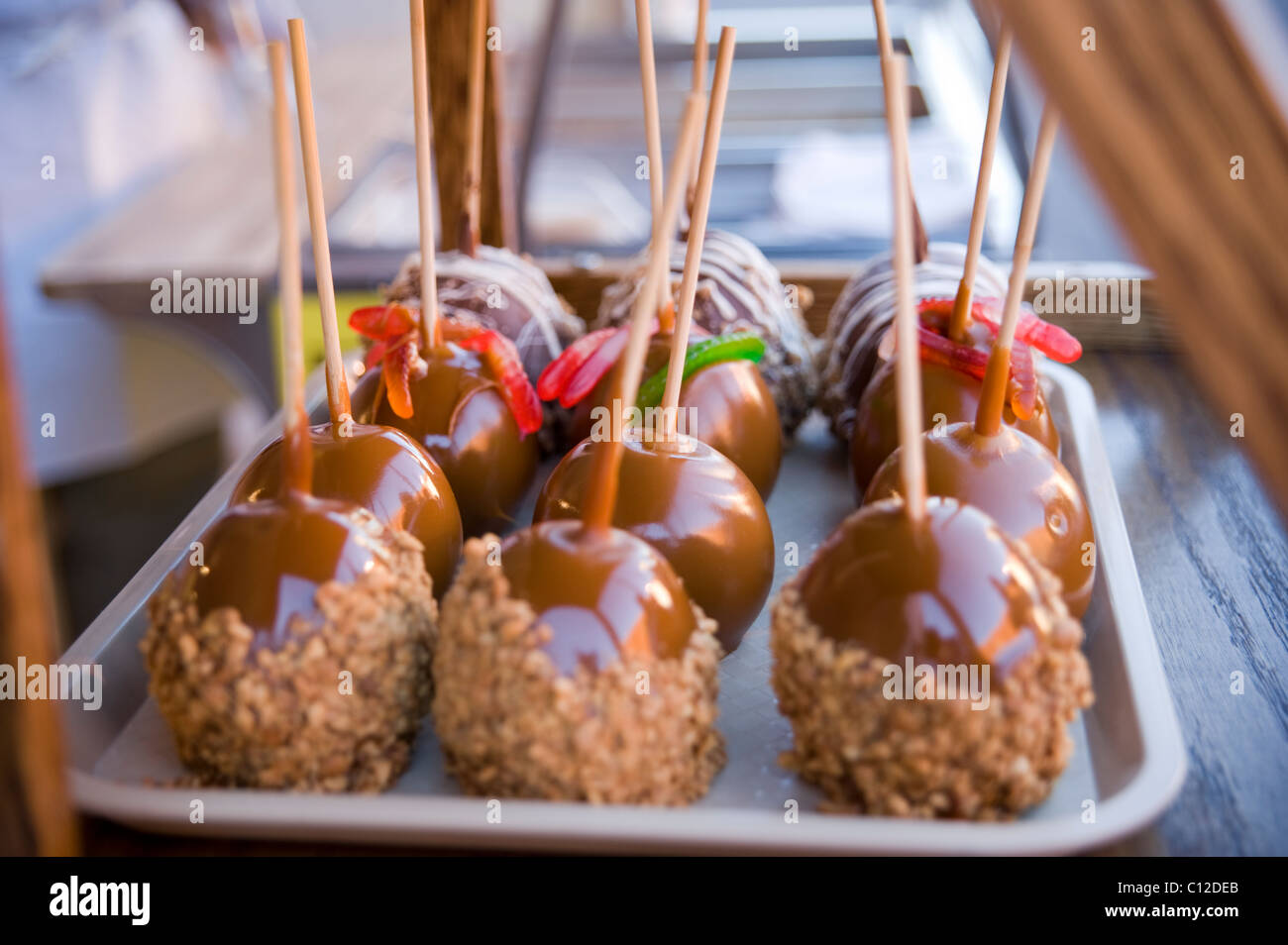 Candied apples for sale at a vendor's booth (some with worms) Stock Photo