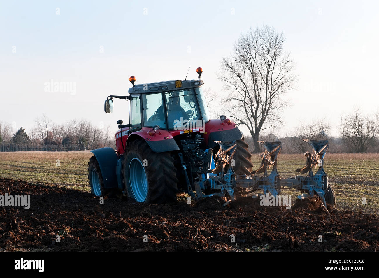 a tractor plowing a field Stock Photo