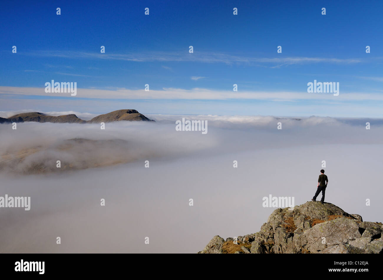 Walker on Great Gable in the English Lake District above a sea of cloud