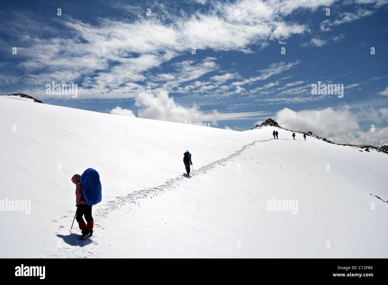 Alpinists at the climbing in Caucasus mountains. Elbrus area. Kabardino-Balkaria. Traces to horizont. Stock Photo