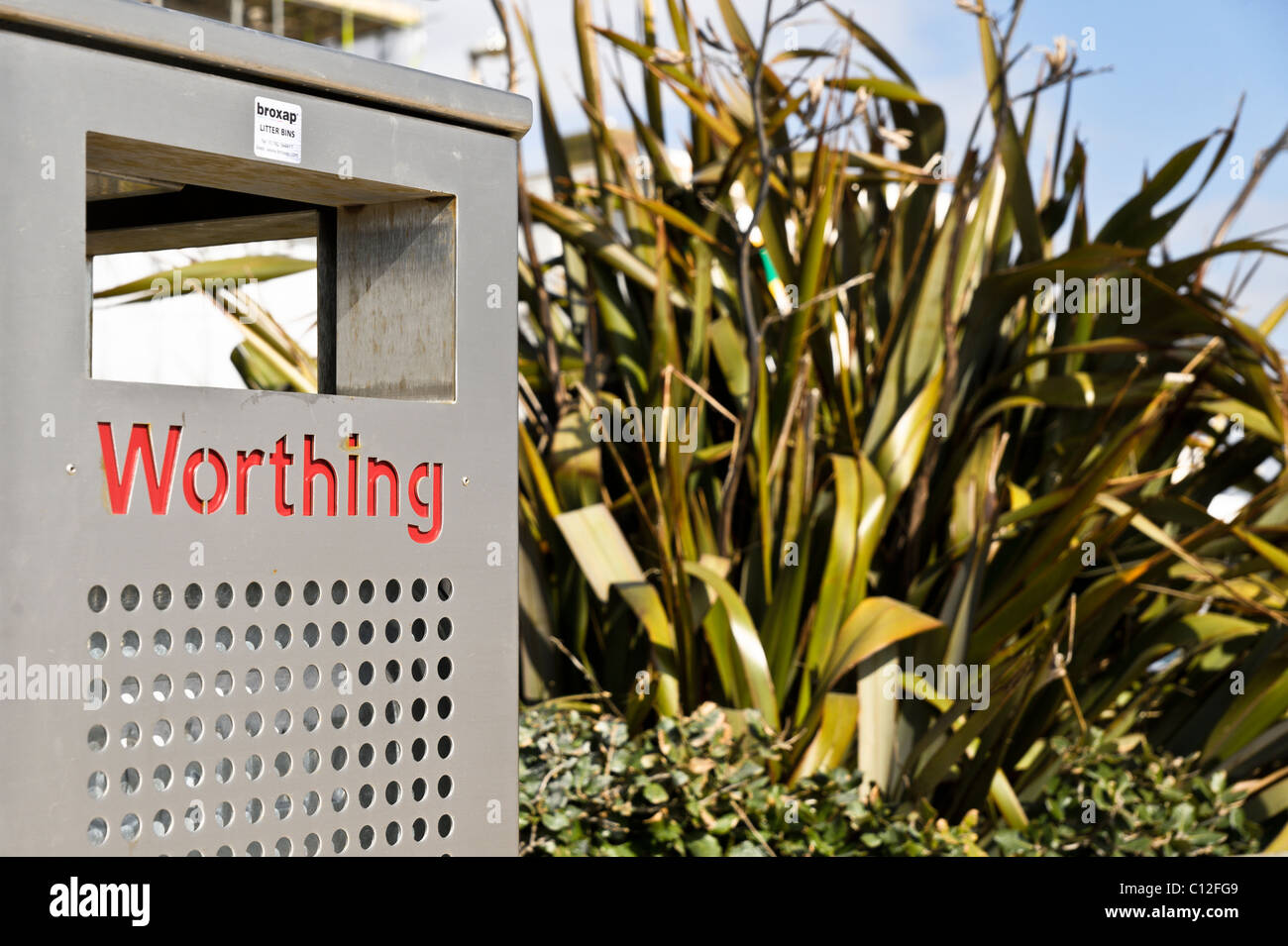 A stainless steel litter bin with the wording "Worthing" in red. Splash