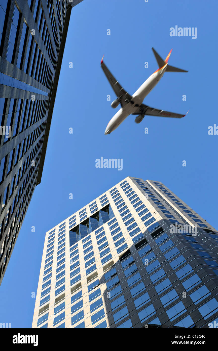 Beijing: airplane over modern buildings Stock Photo