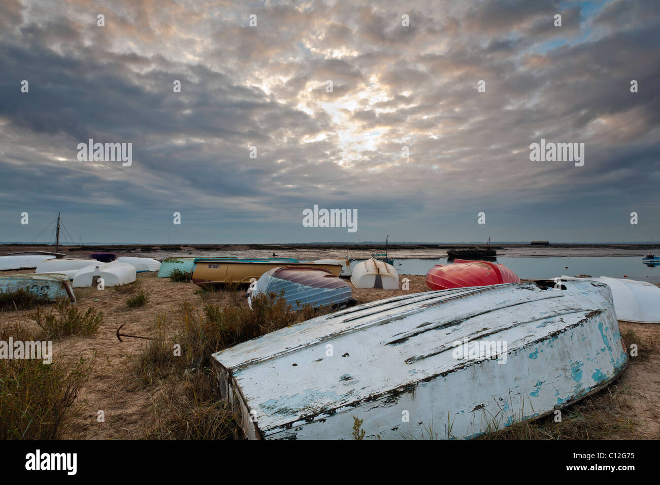 Boat tenders of Mersea Island with a sunset Stock Photo