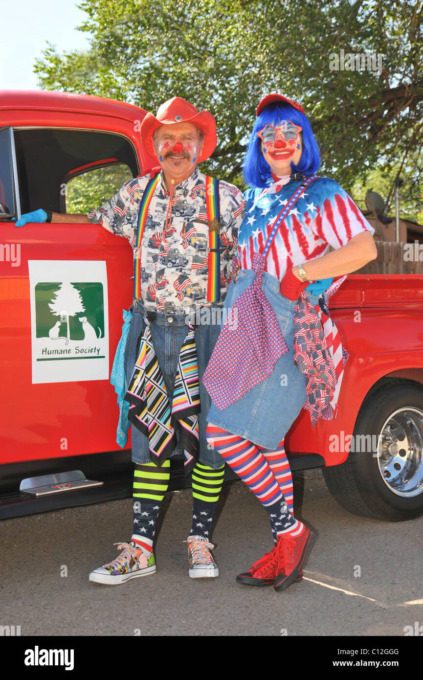 A couple of clowns from the Humane Society are ready for the parade to start in Capitan, New Mexico. Stock Photo