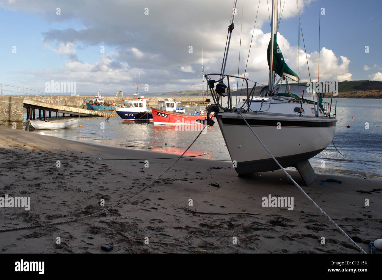 Yacht beached in Newquay harbour, Ceredigion, Wales, United Kingdom Stock Photo