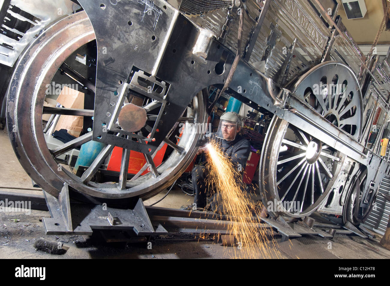 Sculptor Jon Mills welds the frame of his lifesize but two-dimensional artwork based on steam train 'Jenny Lind' Stock Photo