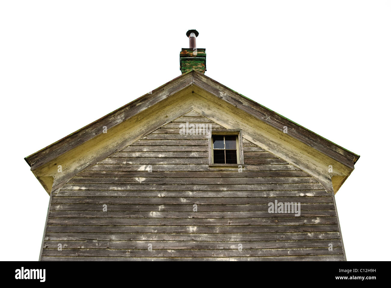 The roof of an old house against a bright clear sky. Stock Photo