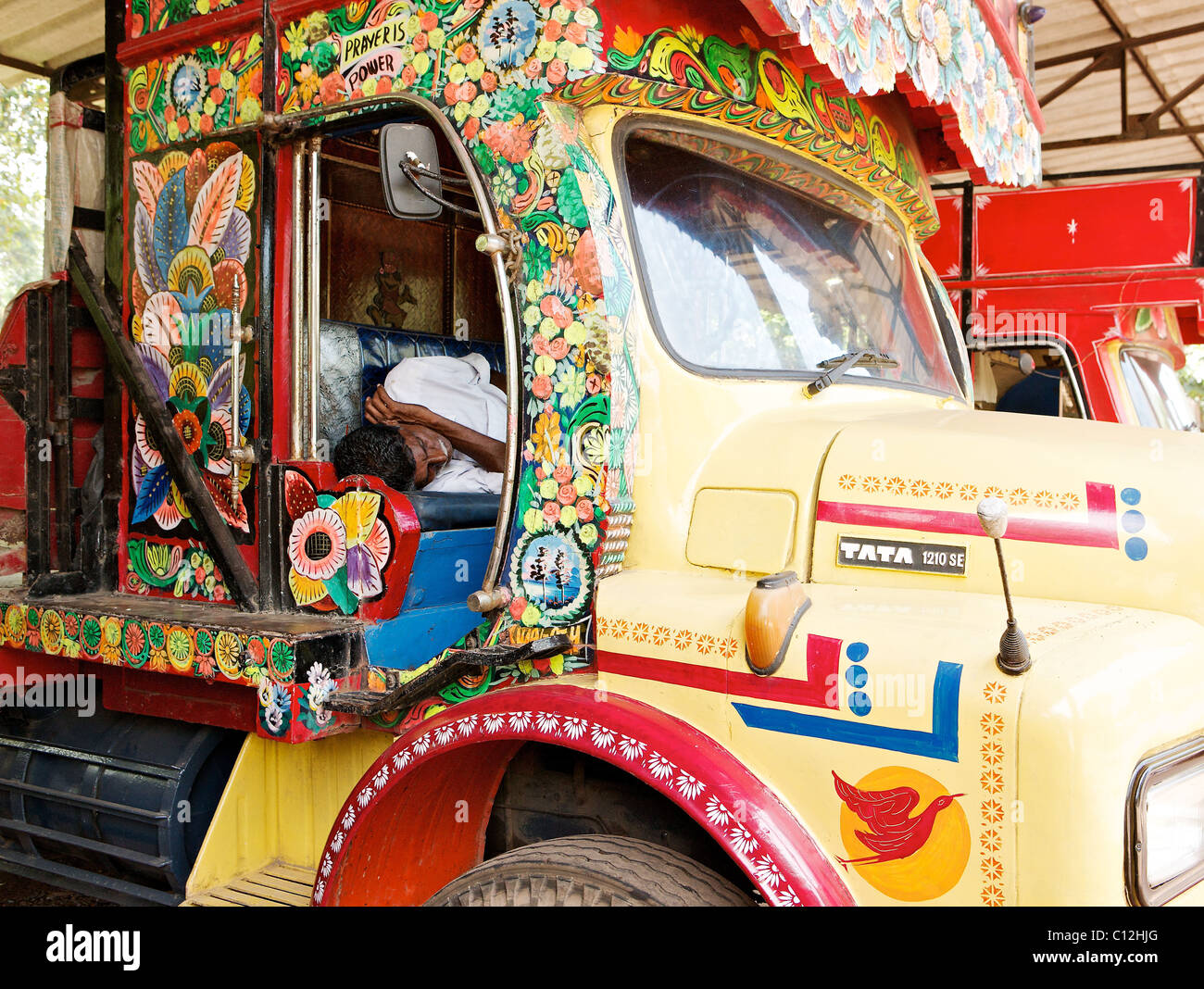 An indian sleeps in the cab or a decorated lorry cab, Kerala, India Stock Photo