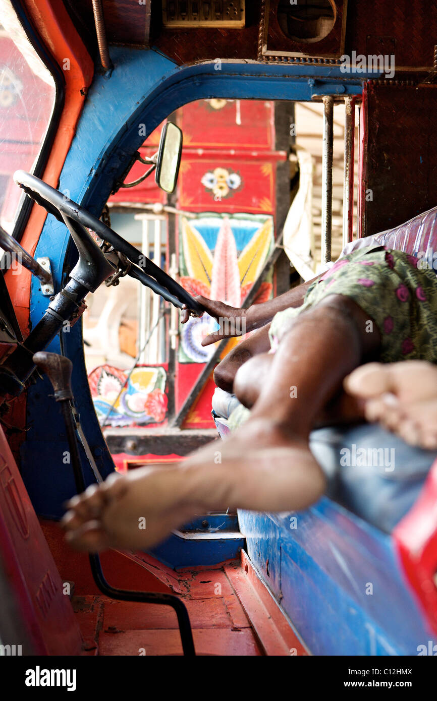 An indian truck driver asleep at the wheel, Kerala, India Stock Photo
