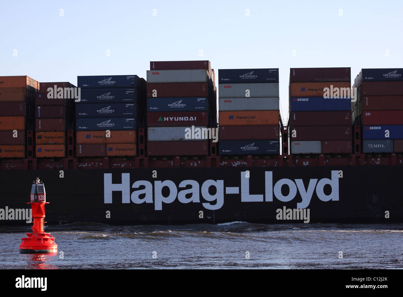 Hapag-Lloyd container ship sailing along the Elbe towards Hamburg harbor.  Shot taken in Blankense. Stock Photo