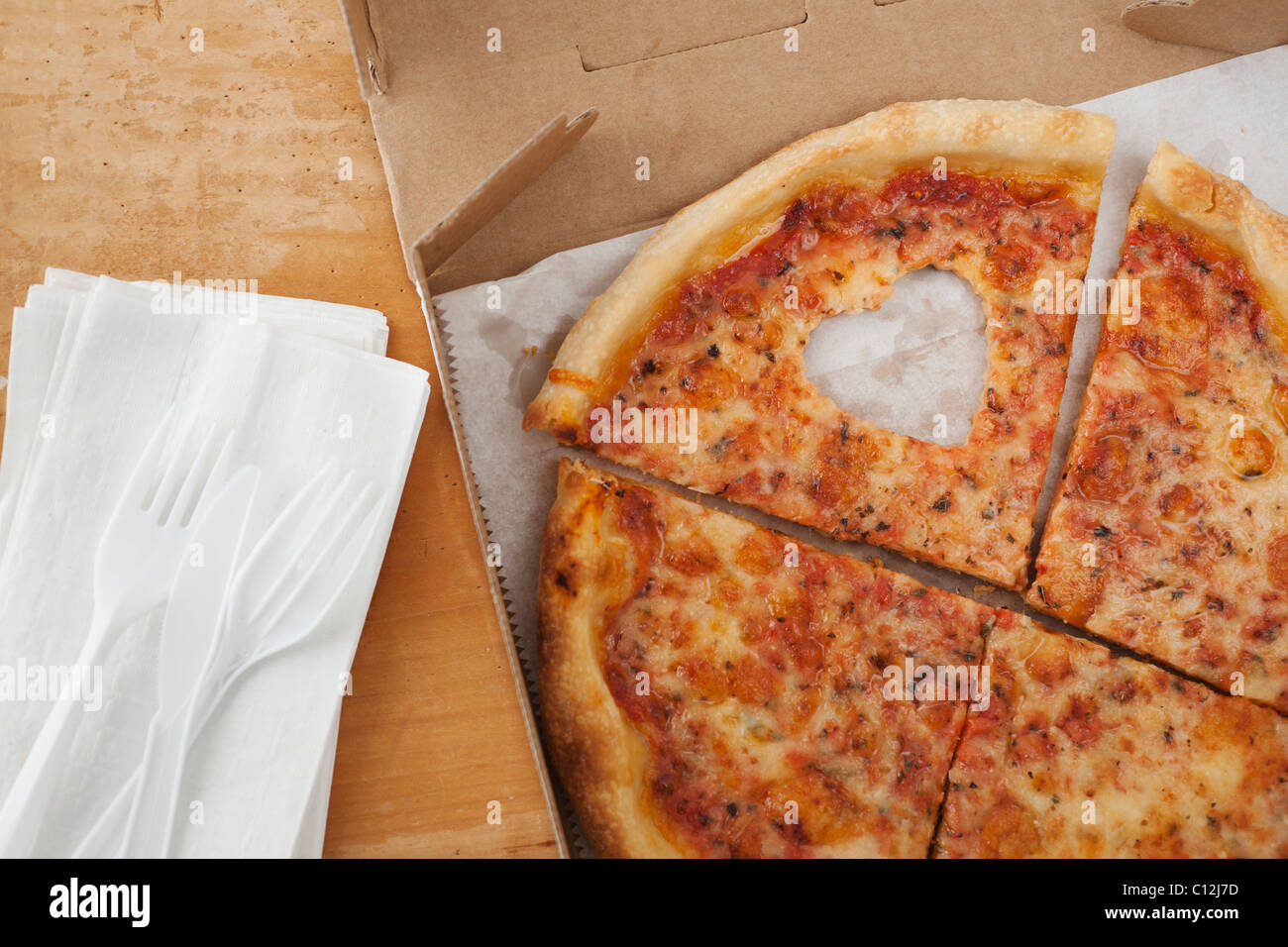 Pizza with missing heart shaped piece Stock Photo