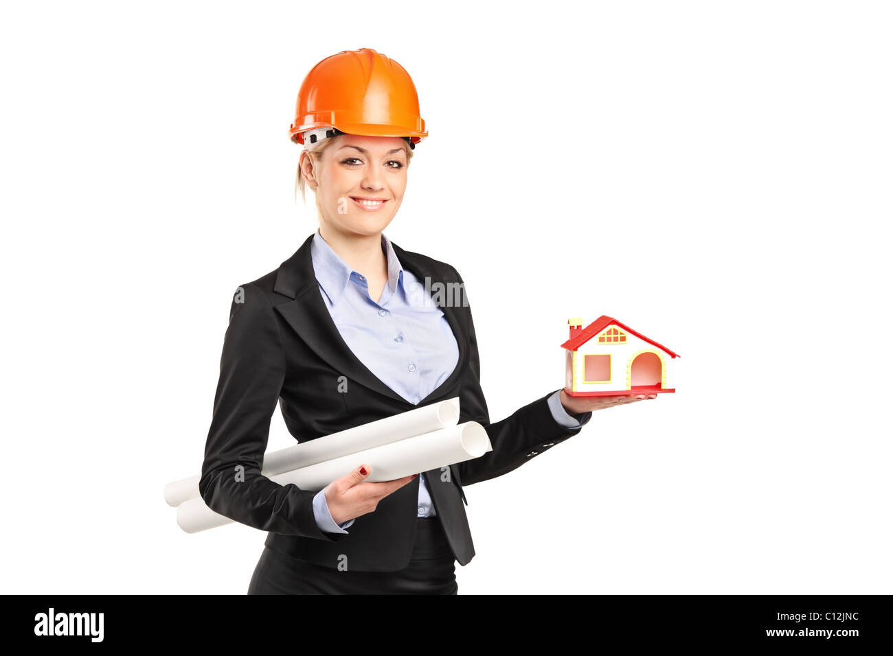 A smiling forewoman holding a model house and blueprints Stock Photo