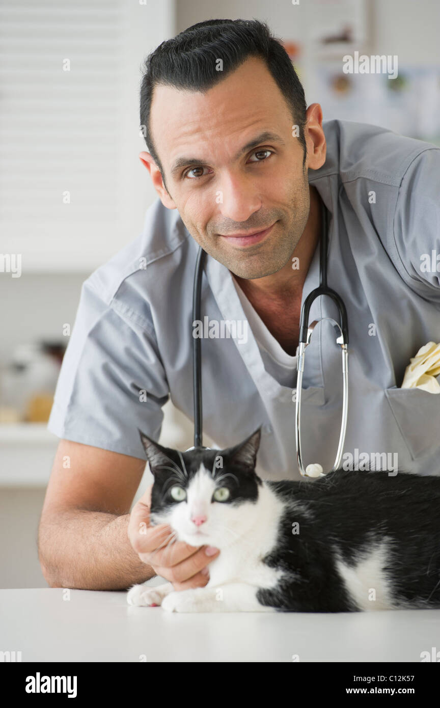 USA, New Jersey, Jersey City, vet stroking cat in pet clinic Stock Photo
