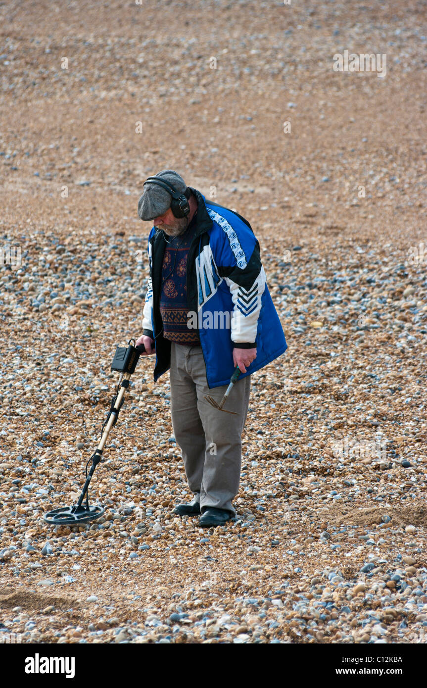 Man On A Beach With A Metal Detector Stock Photo