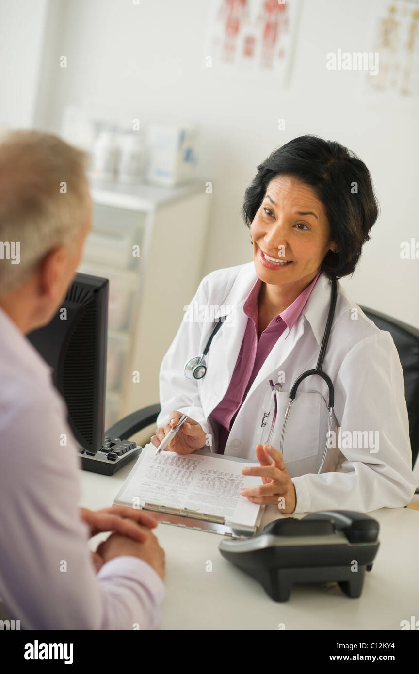 Mature doctor talking female hi-res stock photography and images - Alamy