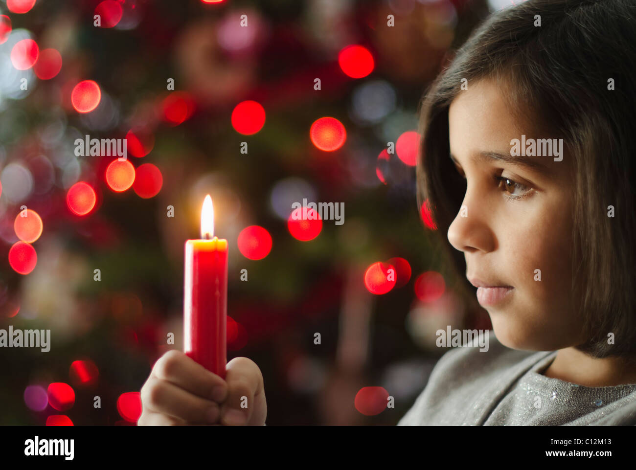 USA, New York City, Girl (8-9) holding christmas candle Stock Photo