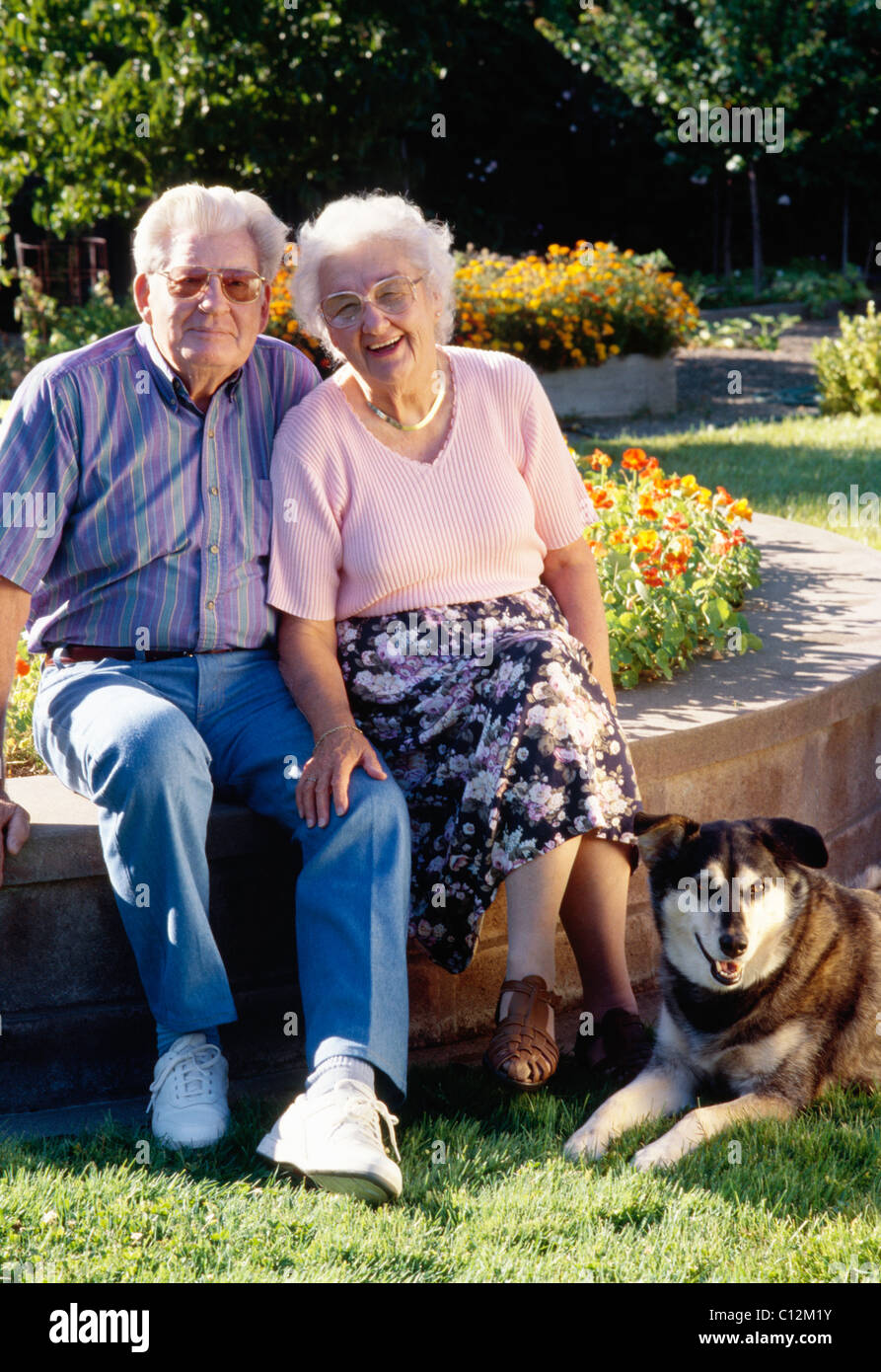 Senior Couple Posing with Pet Dog Stock Photo - Alamy