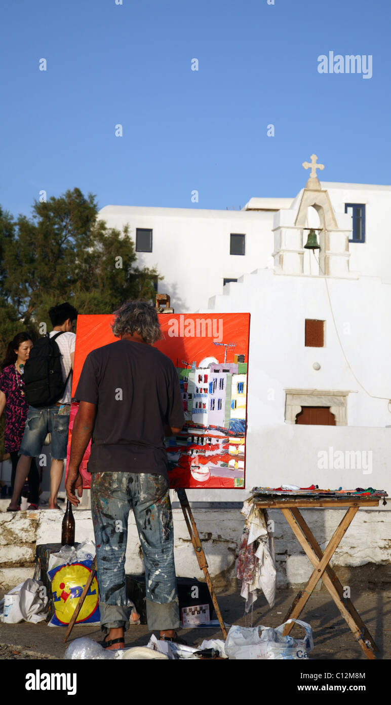 Painter working on a painting of a Greek Orthodox Church, Little Venice, Mykonos Town (Chora), Mykonos, Cyclades, Greece Stock Photo