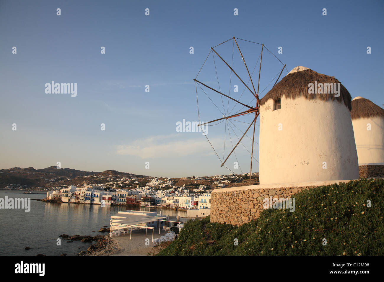 Windmills in late afternoon sunlight, Little Venice, , Mykonos Town (Chora), , Mykonos, Cyclades, Greece Stock Photo