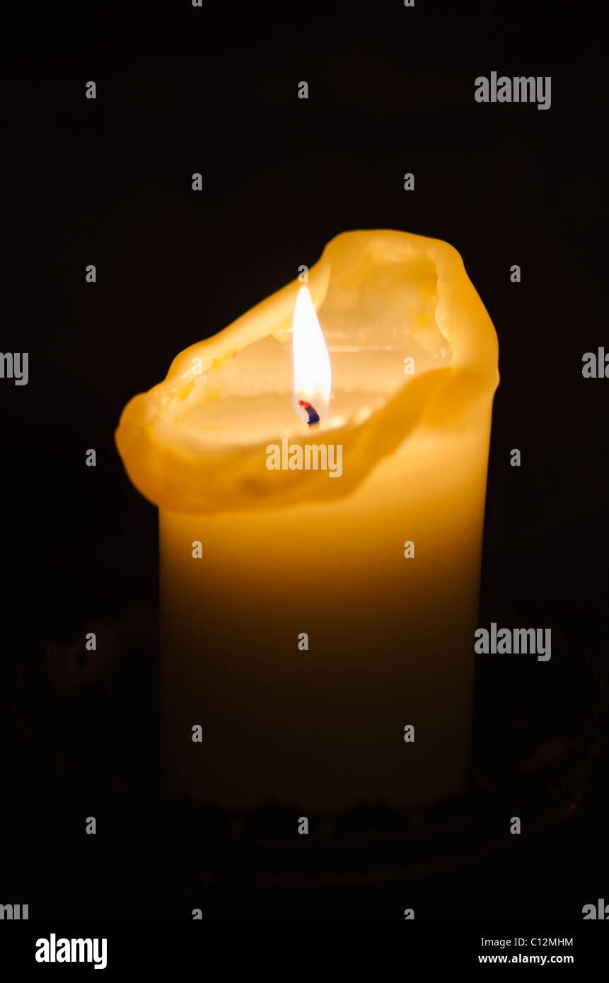 Illuminated candle on black background Stock Photo Alamy