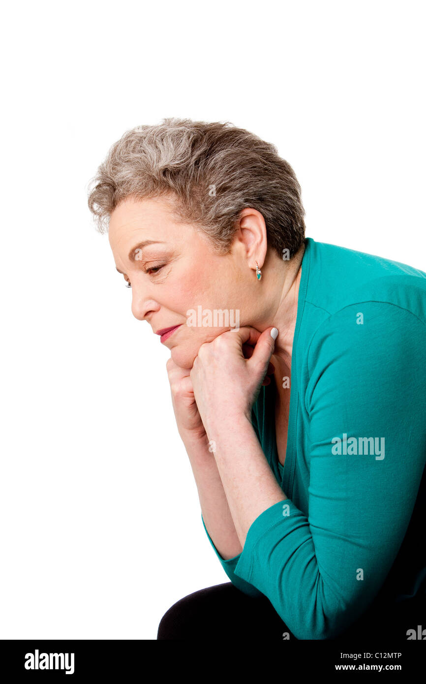 Beautiful Senior woman worried leaning forward on her hands thinking of her future or past life, isolated. Stock Photo