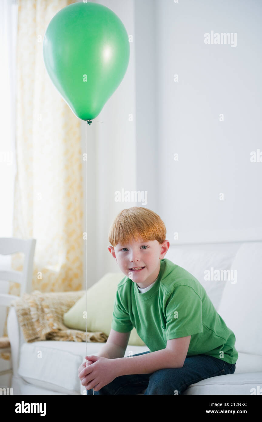 USA, New Jersey, Jersey City, portrait of boy (8-9) with green balloon Stock Photo