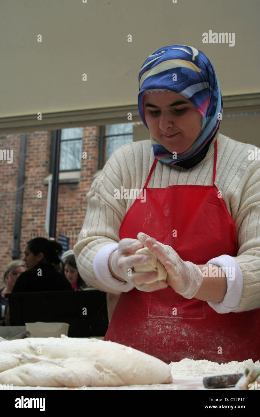 A Muslim woman making Turkish bread at the Street Coffee Festival, Sydney, NSW, Australia