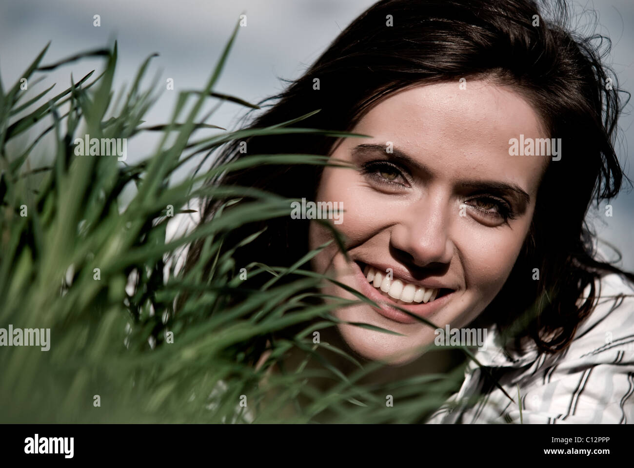 Portait of young woman in grass Stock Photo