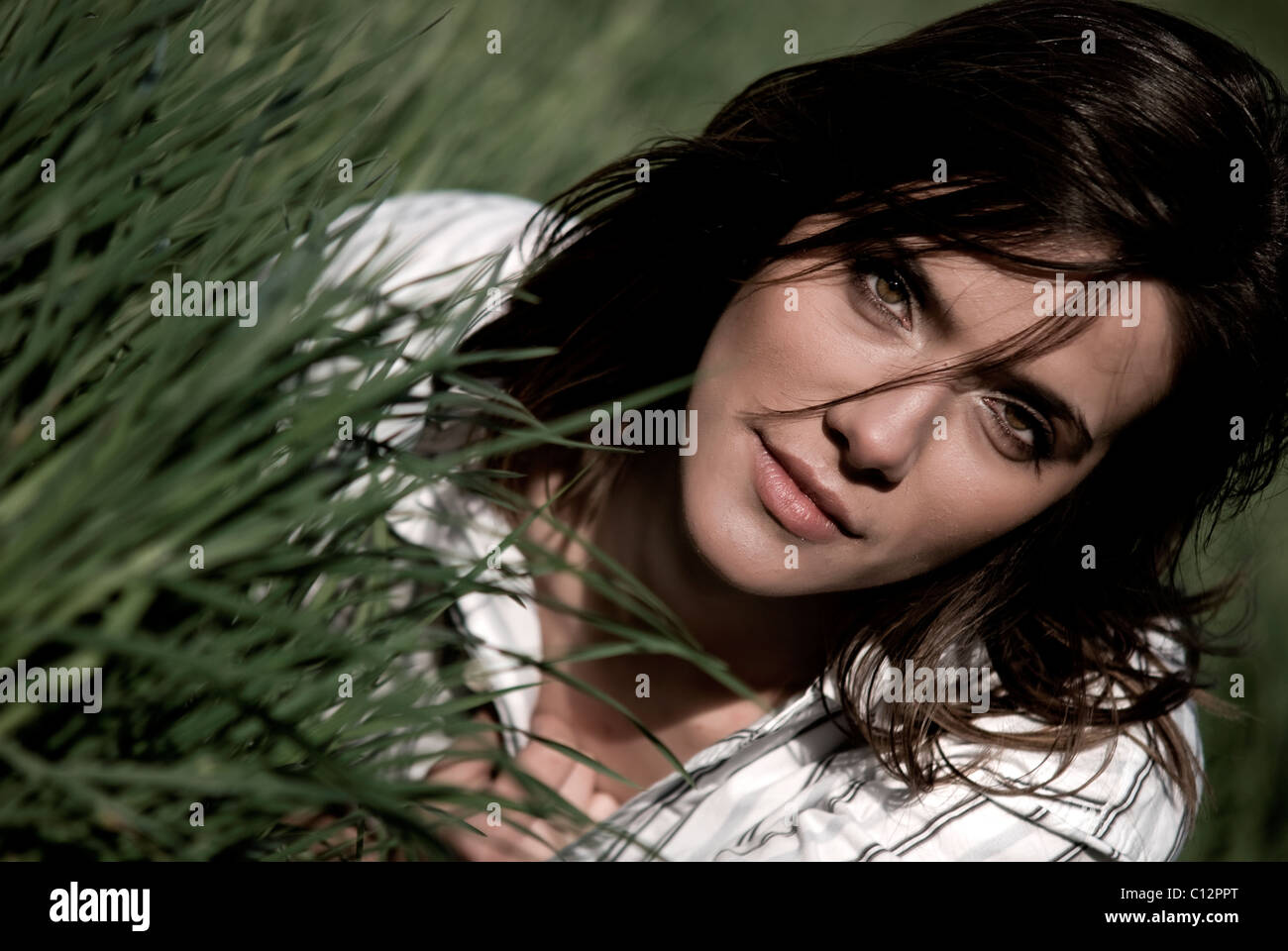 Portait of young woman in grass Stock Photo