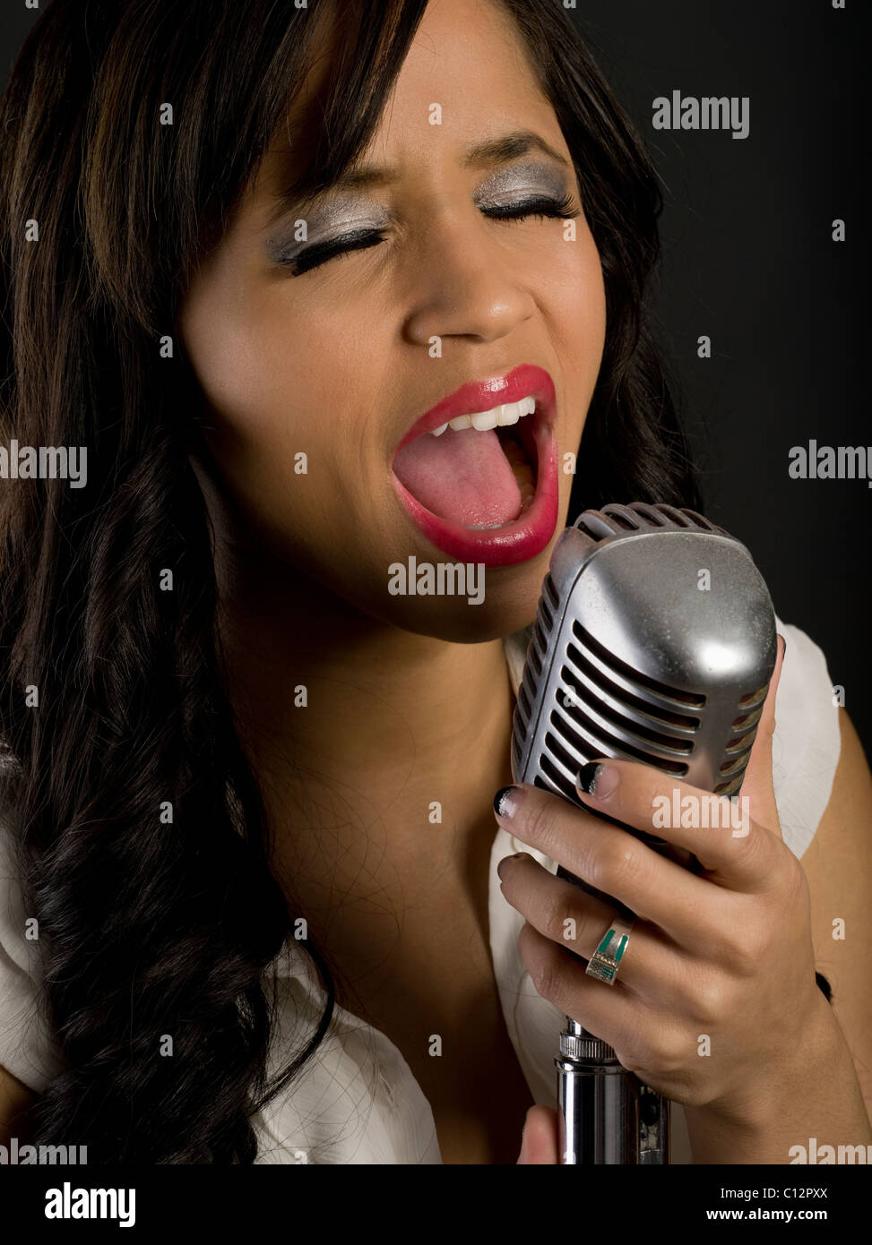 Portrait of beautiful Filipina American Woman singing Stock Photo
