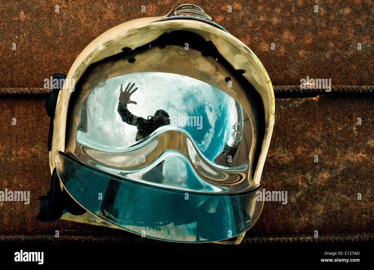 Reflection in a visor of a man waving Stock Photo