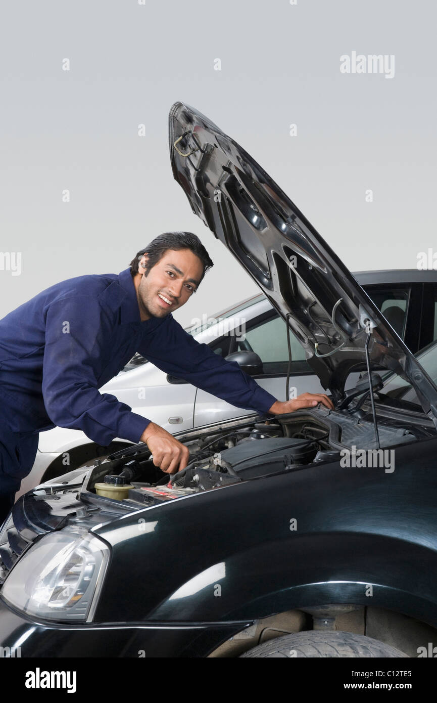 Auto mechanic repairing a car in a garage Stock Photo