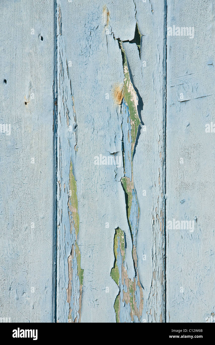 Peeling paint on a neglected garage door. Stock Photo