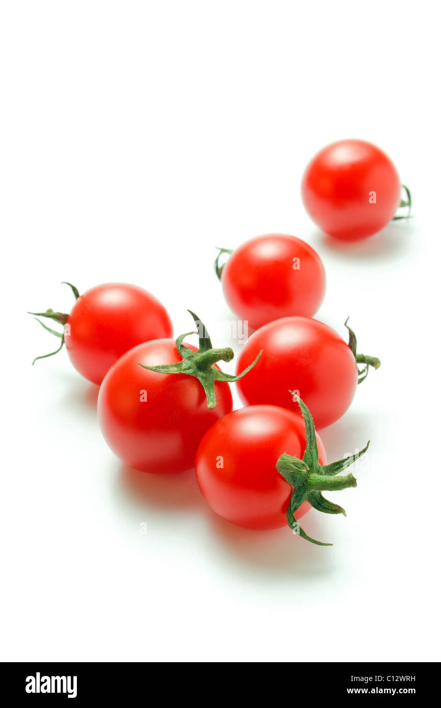 Fresh ripe cherry tomatoes scattered isolated on a white background ...
