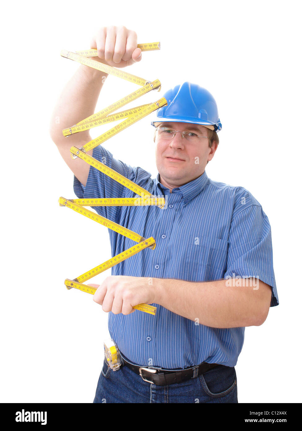 Civil engineer wearing blue helmet unfolding yellow folding rule over white Stock Photo