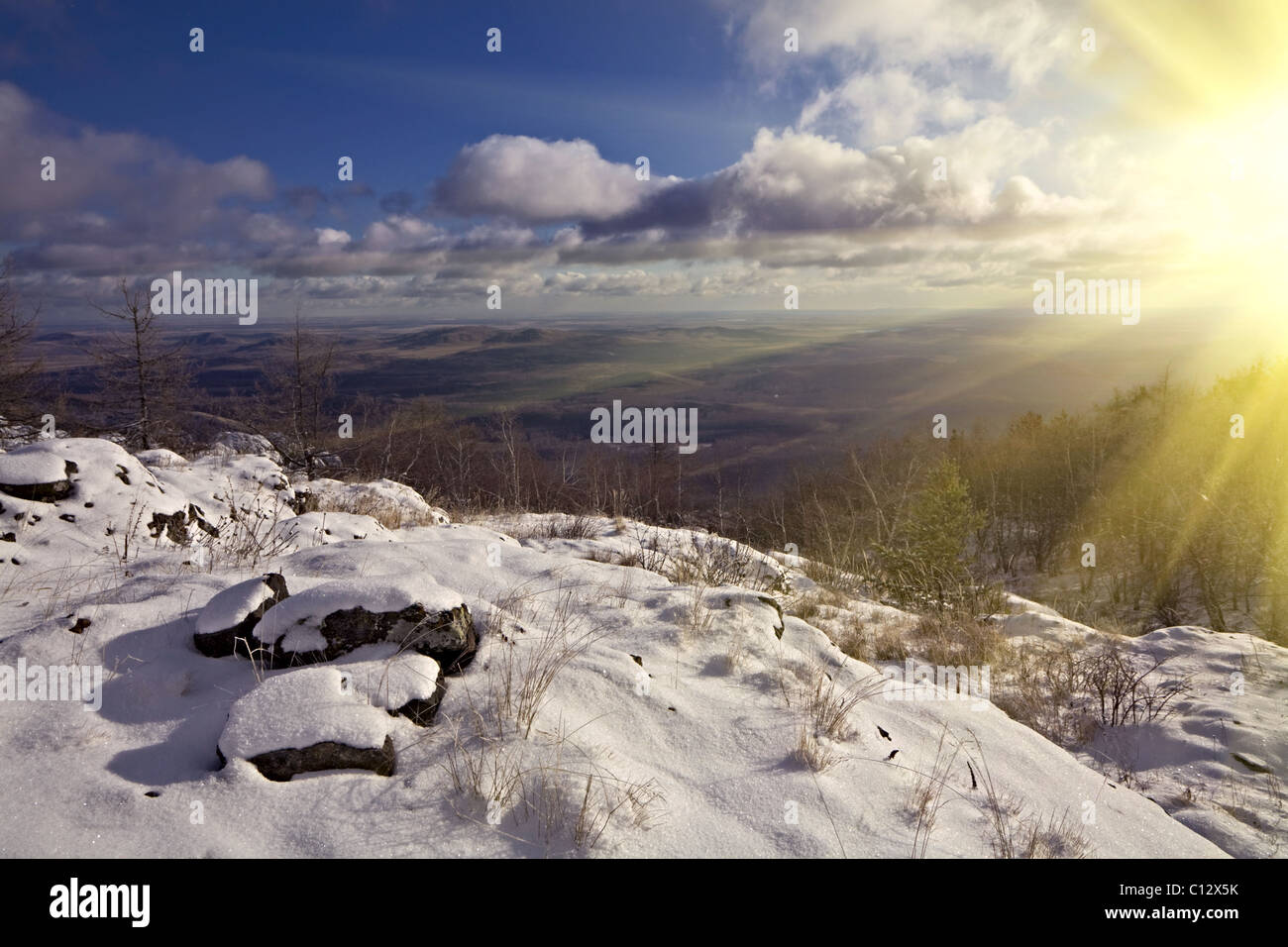 Winter landscape with shining sun and clouds Stock Photo