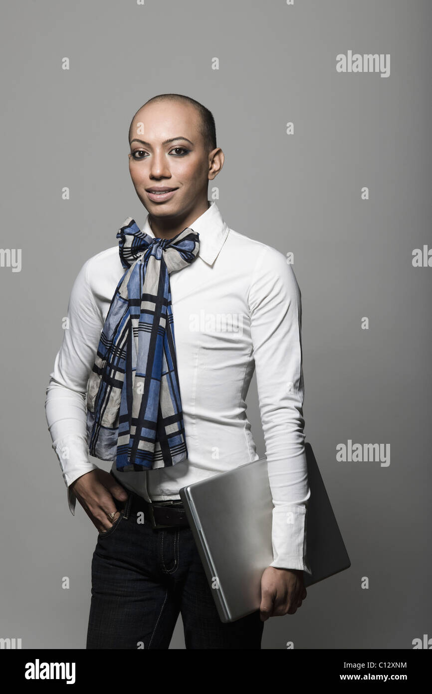 Gay businessman holding a laptop and smiling Stock Photo