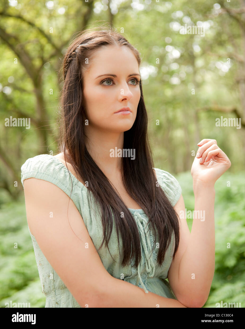 portrait of young woman standing in a forest Stock Photo - Alamy