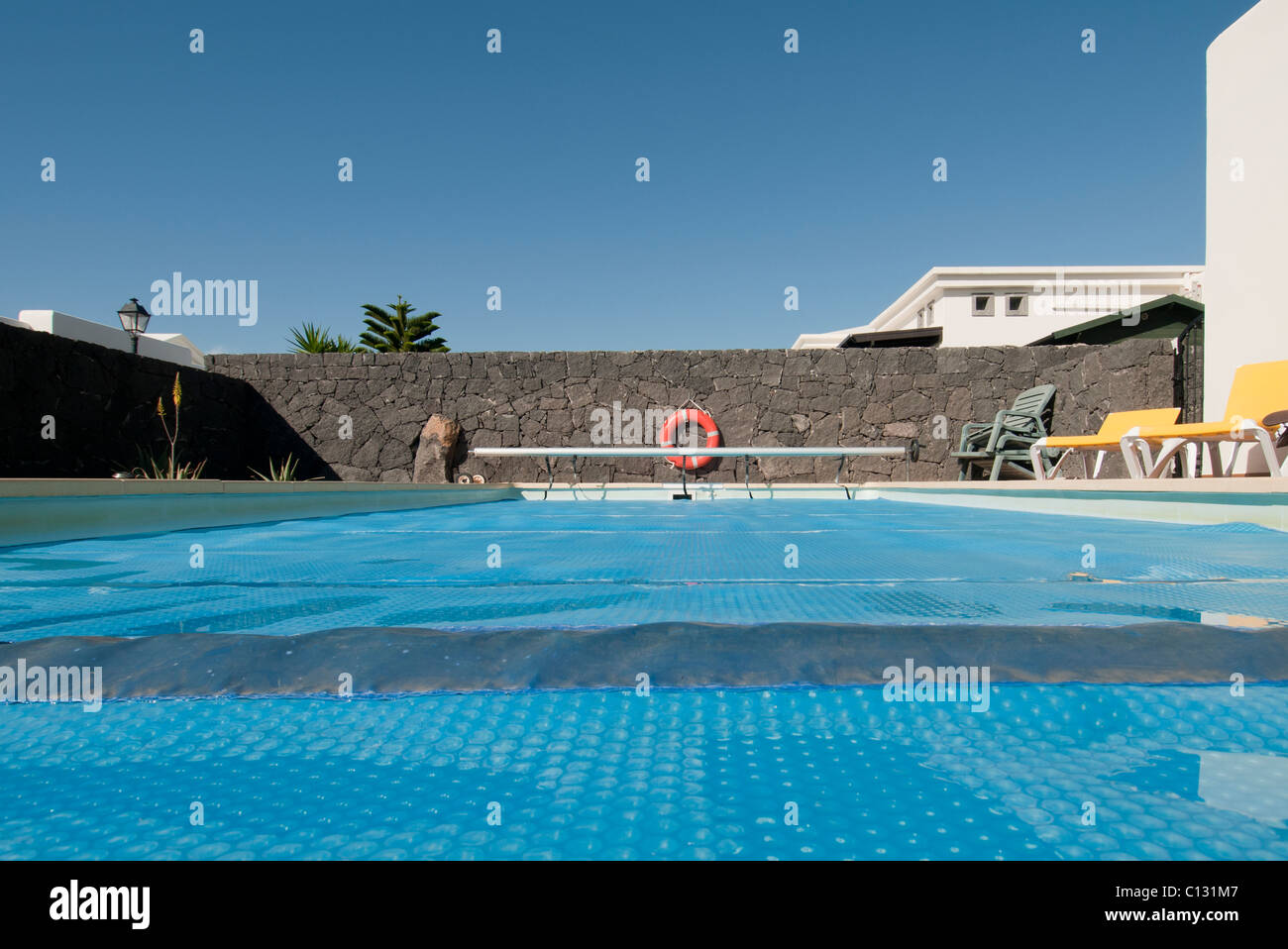 swimming pool cover over a pool at a holiday villa. Stock Photo