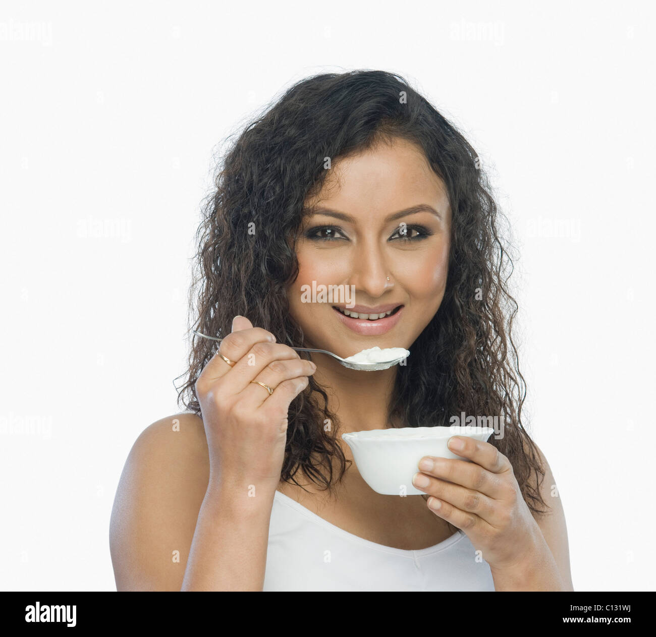 Portrait of a woman eating yogurt Stock Photo