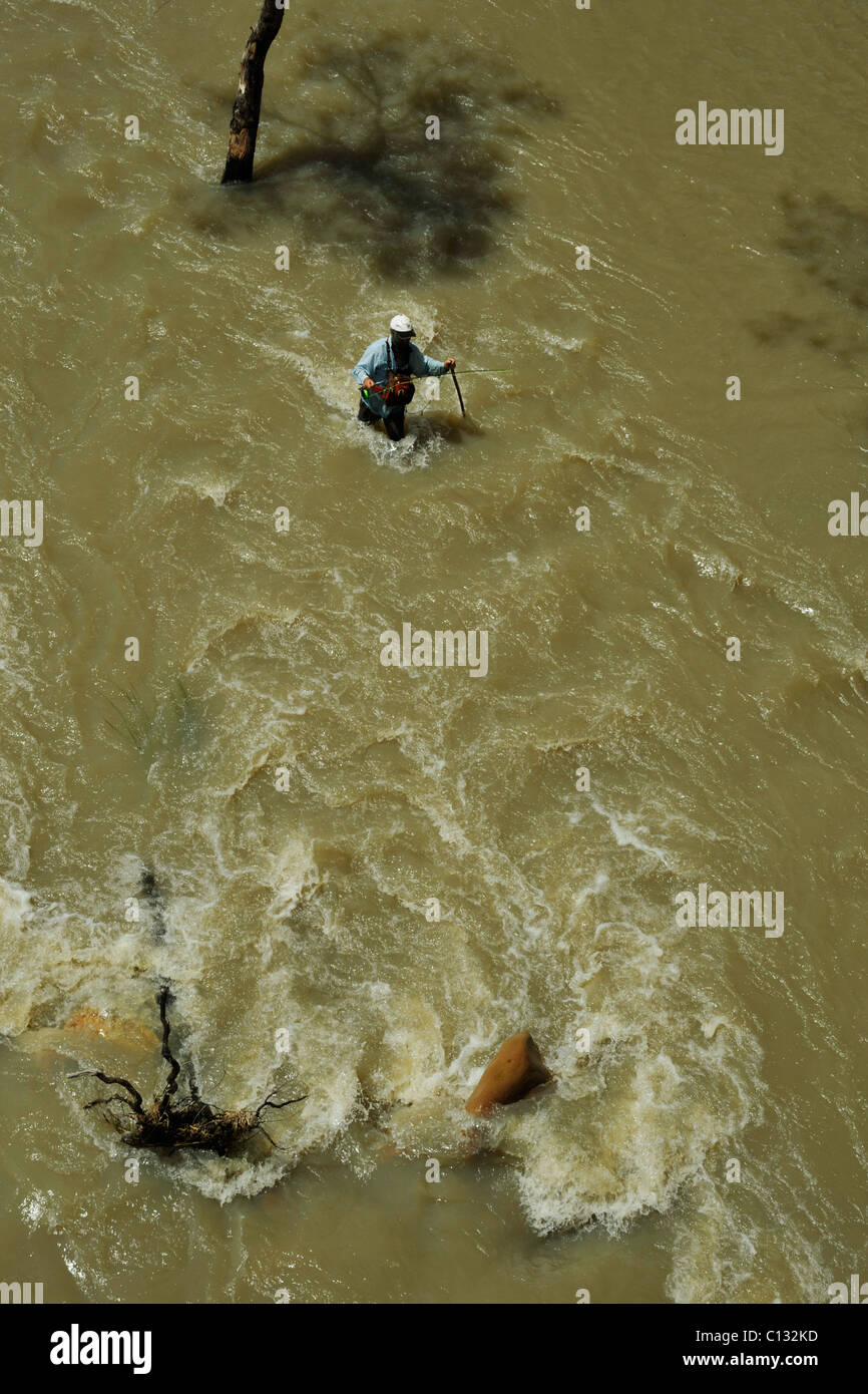 Scene of fly fisherman fishing for local species of Yellow Fish in fast