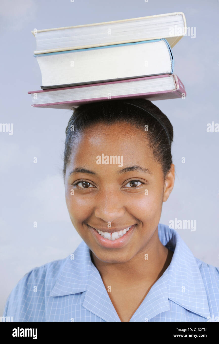 School girl with books balanced on her head, Cape Town, South Africa Stock Photo