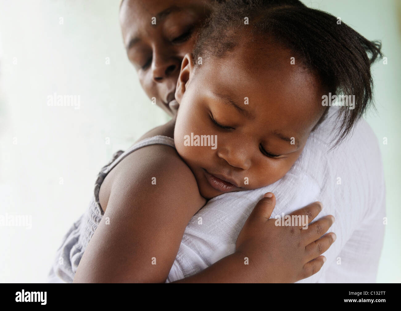 Mother holding her sleeping  daughter. Cape Town, South Africa Stock Photo