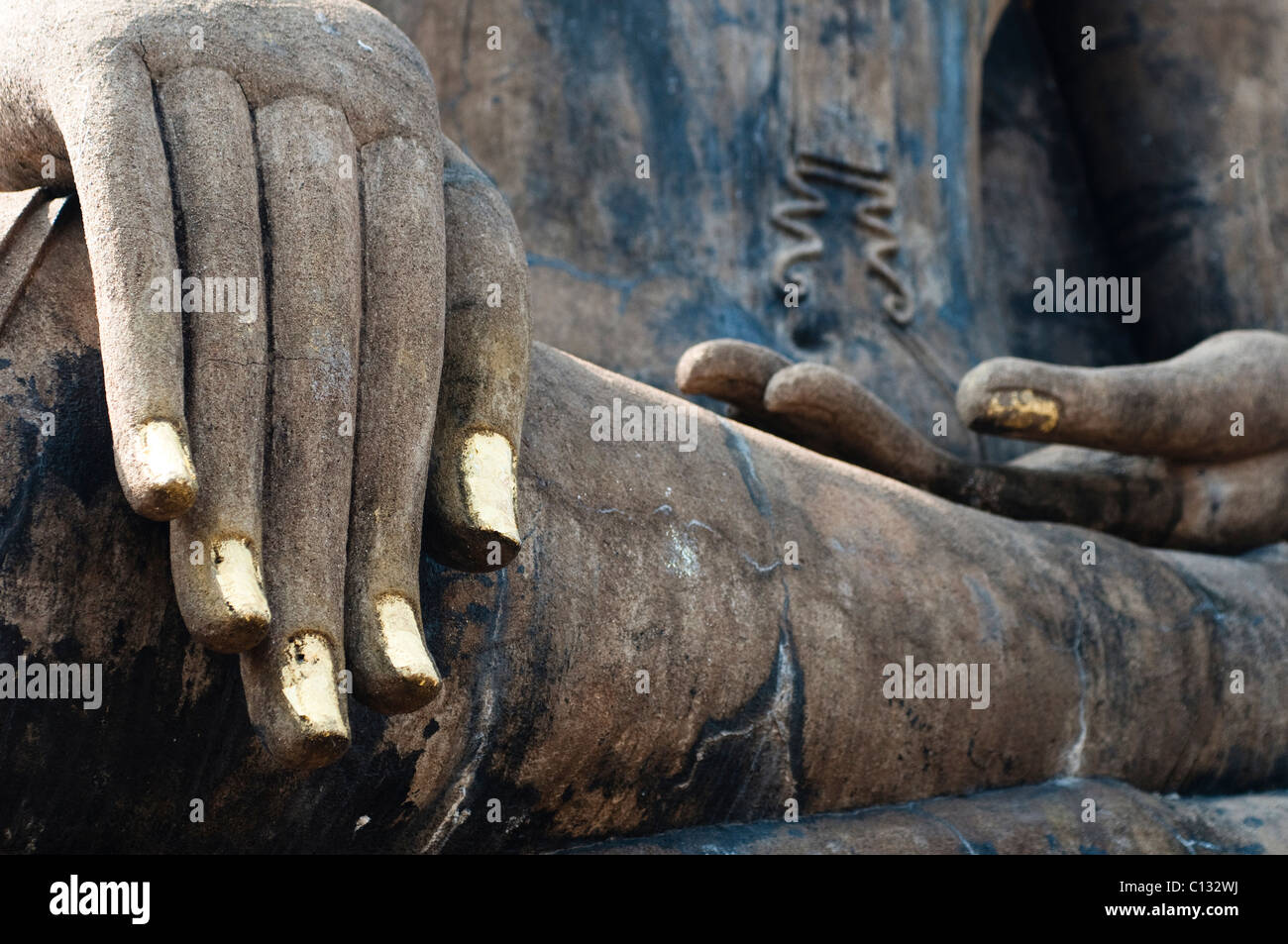 Buddha's fingernails painted with gold paint Wat Mahathat, Sukhothai Historical Park, Thailand Stock Photo
