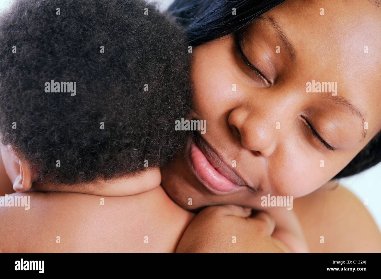 Close up of mother hugging her baby, Cape Town, South Africa. Stock Photo